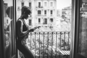 Beautiful black woman relaxing with mobile phone